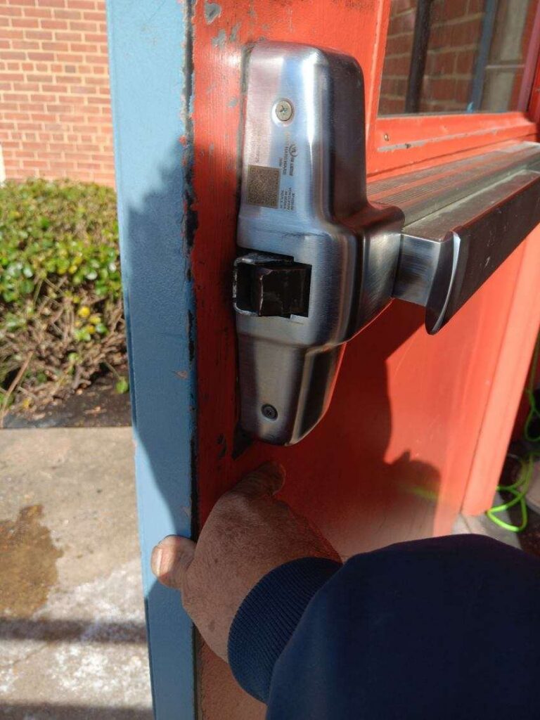 Panic bar hardware on a red commercial door