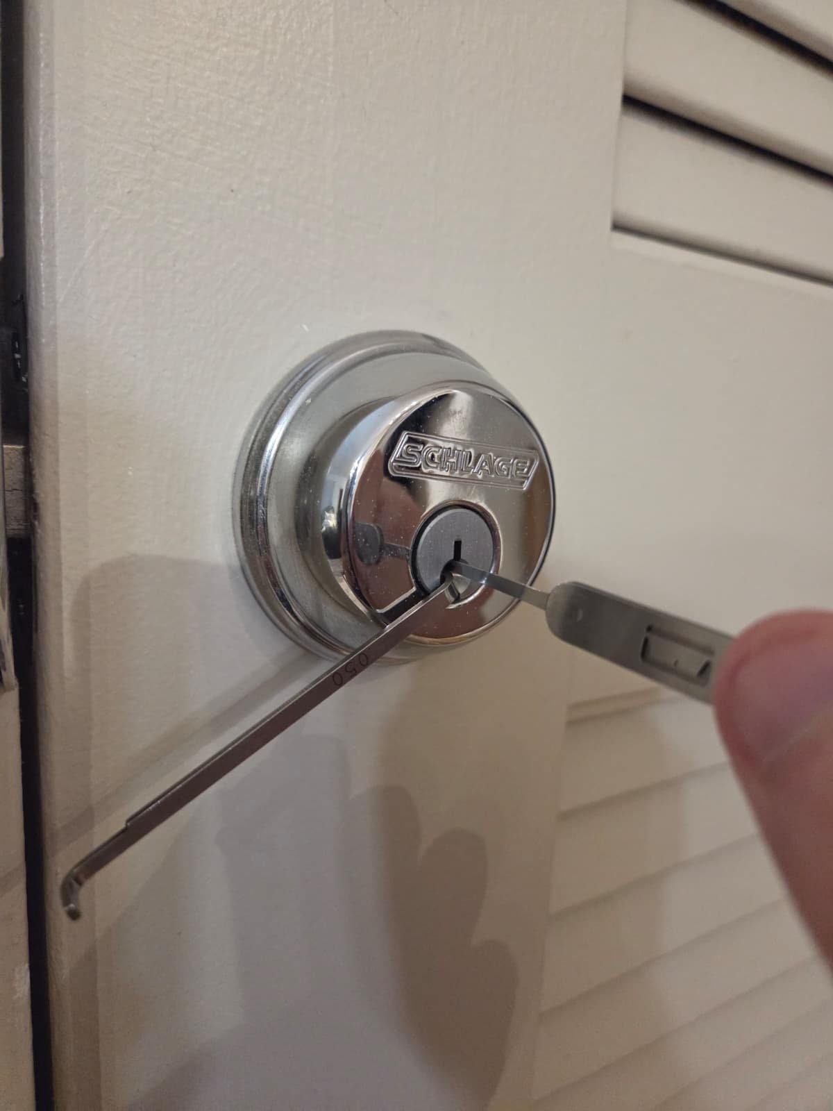Tools positioned in a residential deadbolt keyway