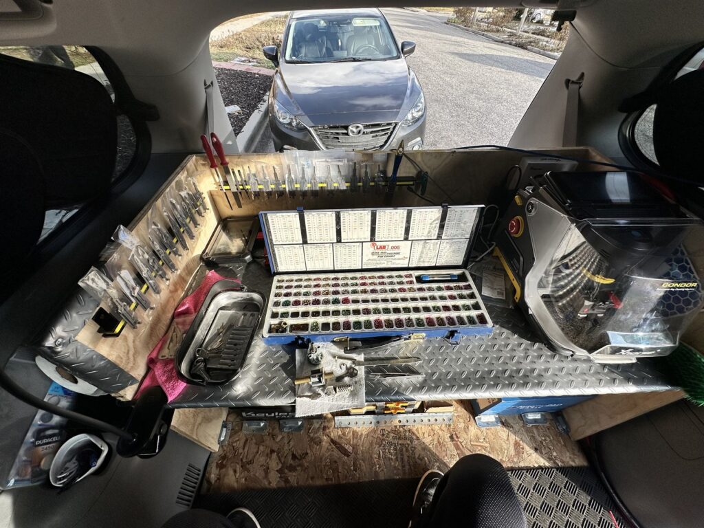 Locksmith key cutting tools set up inside a vehicle